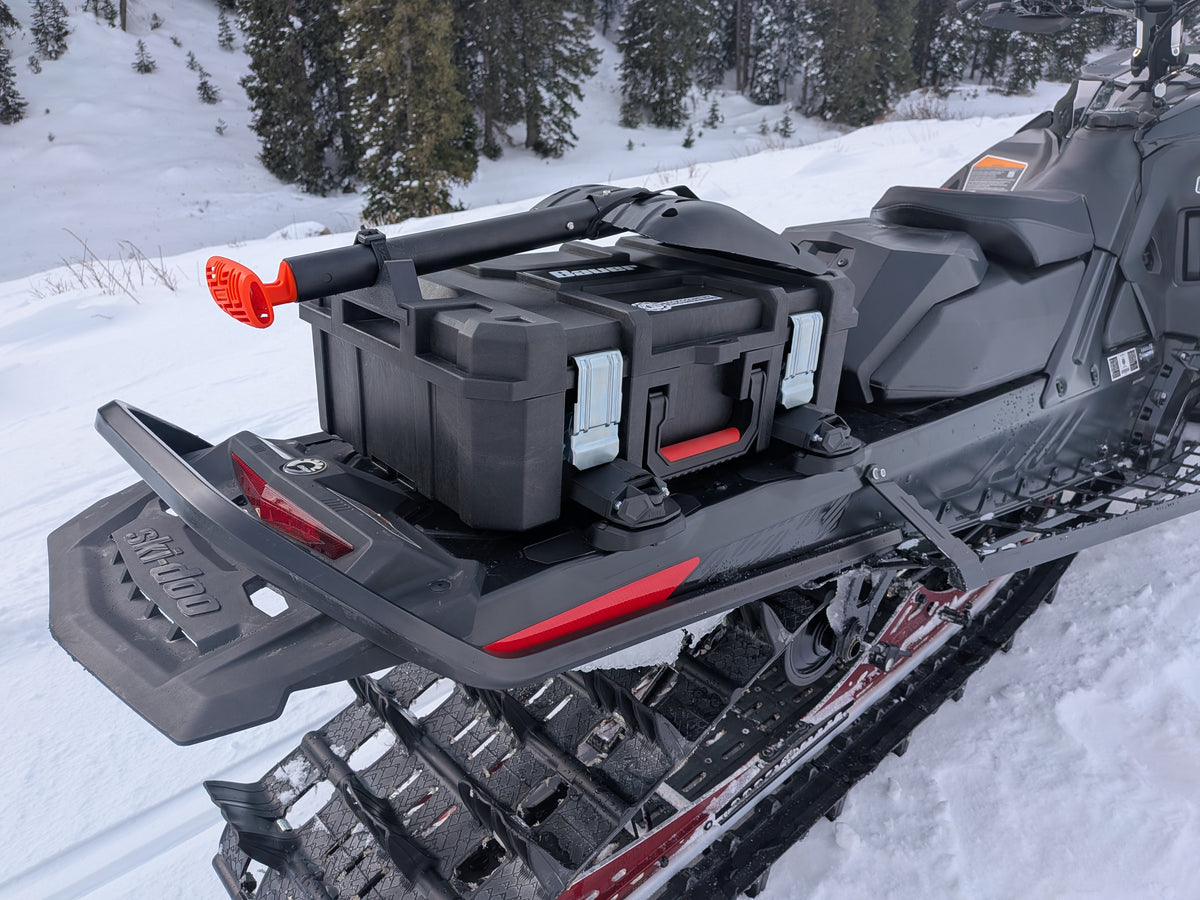 Snowmobile with storage box on a snowy landscape