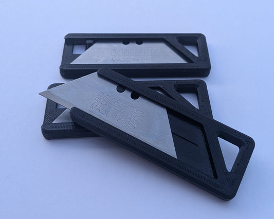Black multitool with a silver blade on a light blue background